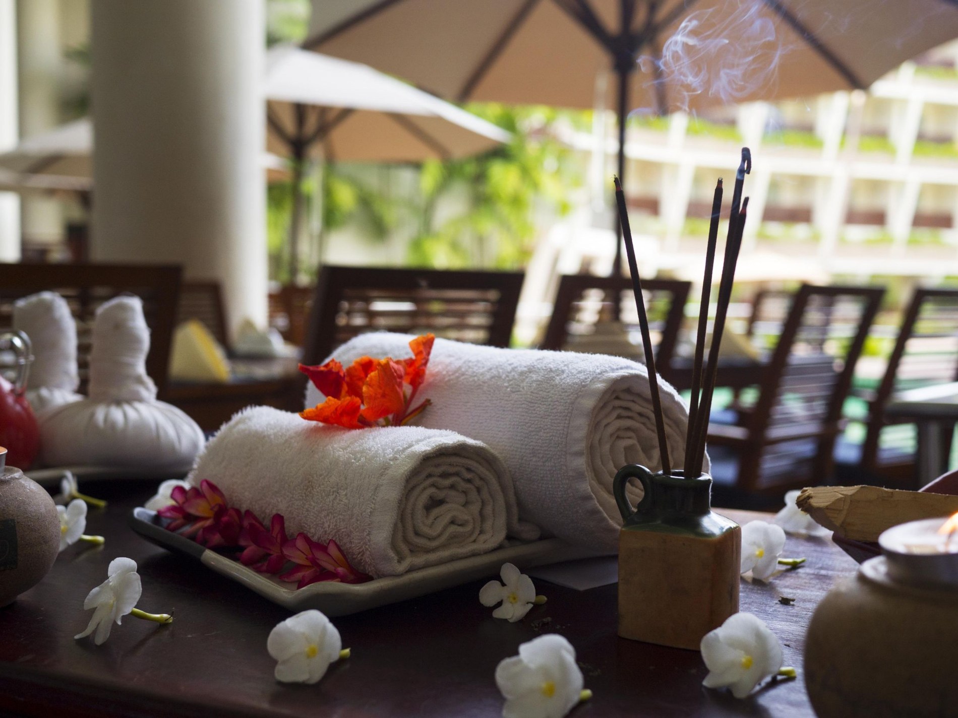 Spa towels, flowers and incense in warm natural light